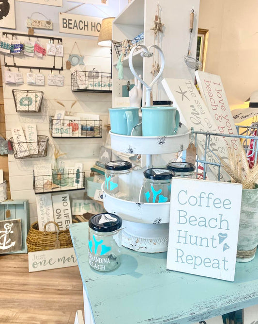 coastal home decor display with handmade in usa coastal signs by anchored soul designs arranged on a shelf