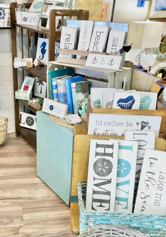 Eye-catching retail display with handmade wood beach signs in a coastal gift shop