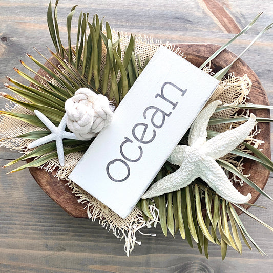 Top Coastal Decor Trends Retail Shops Should Stock This Year, ocean sign in wood bowl with coastal textures and decor