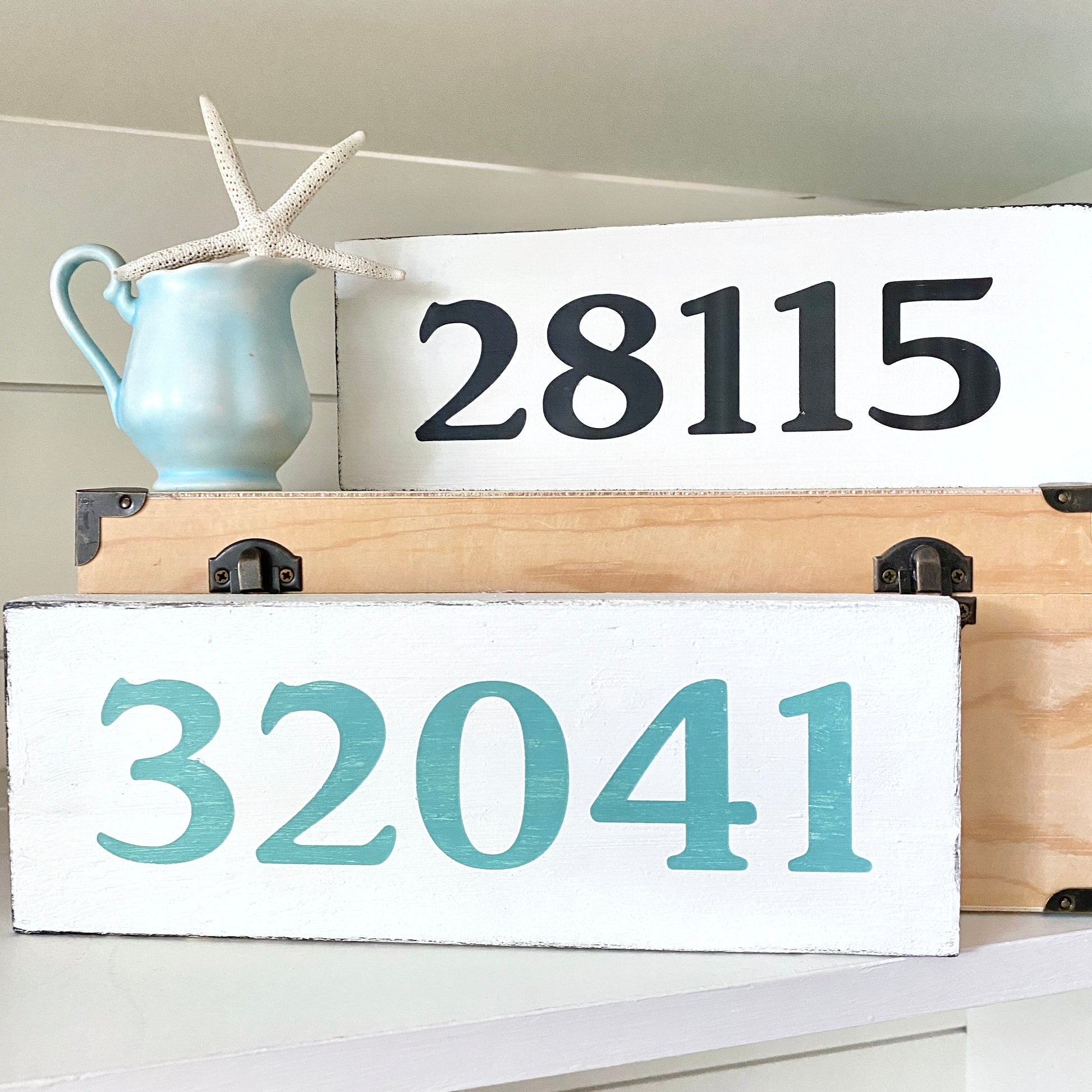 Wooden signs with zip code '28115' and '32041' on a white background.