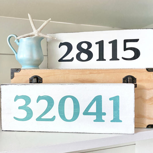 Wooden signs with zip code '28115' and '32041' on a white background.