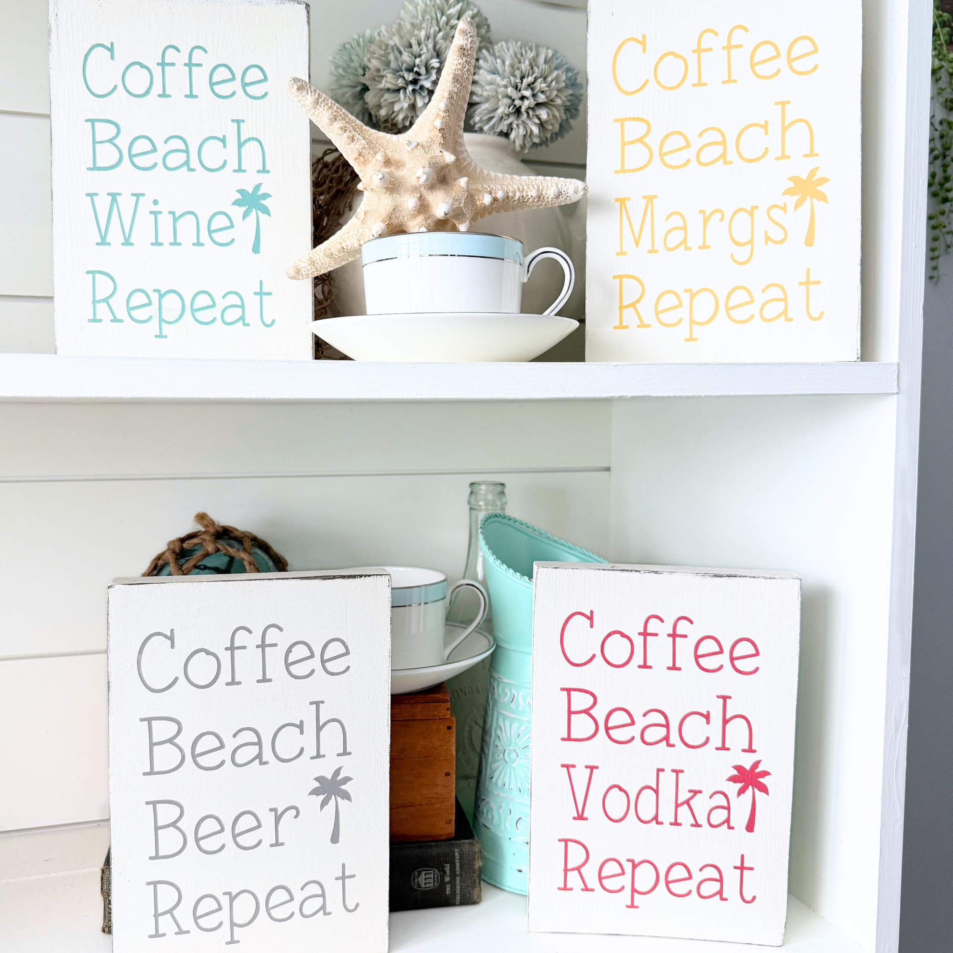 Decorative signs with humorous phrases on a shelf with decorative items. Coffee beach repeat signs